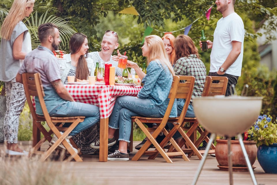 People gathered on a new deck by blue nail exteriors
