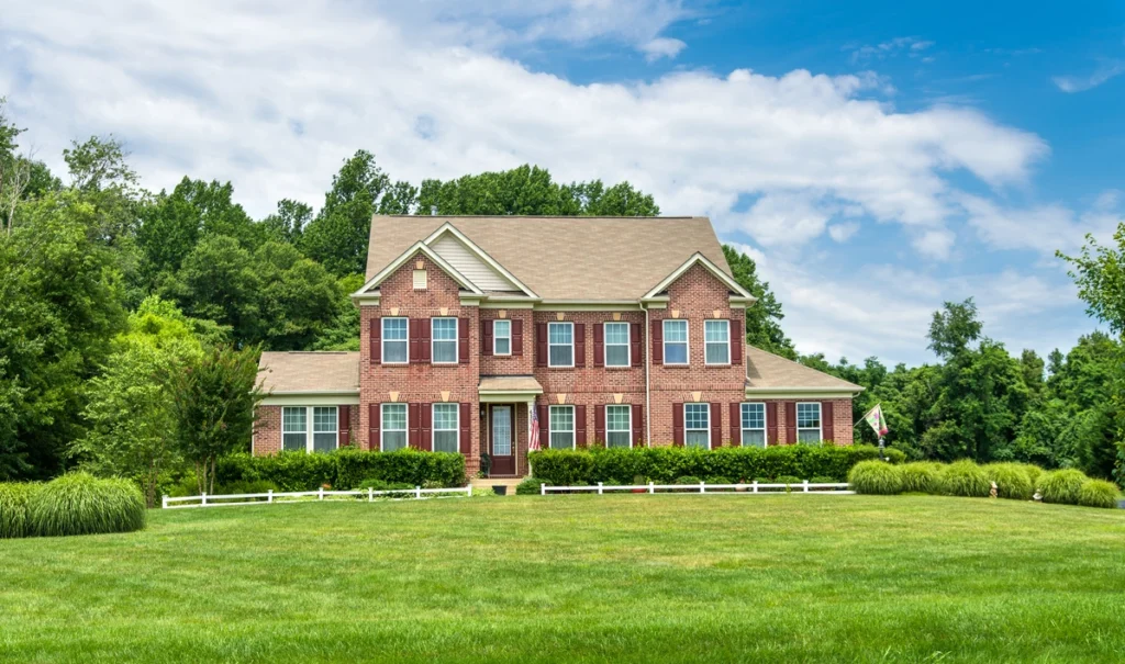 brick house with brown asphalt shingle roof