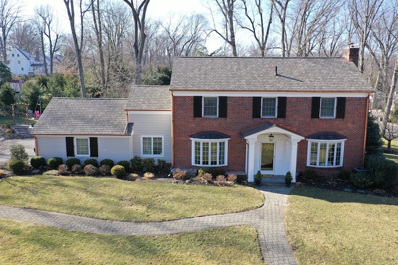 copper gutter installation on brick home by blue nail exteriors