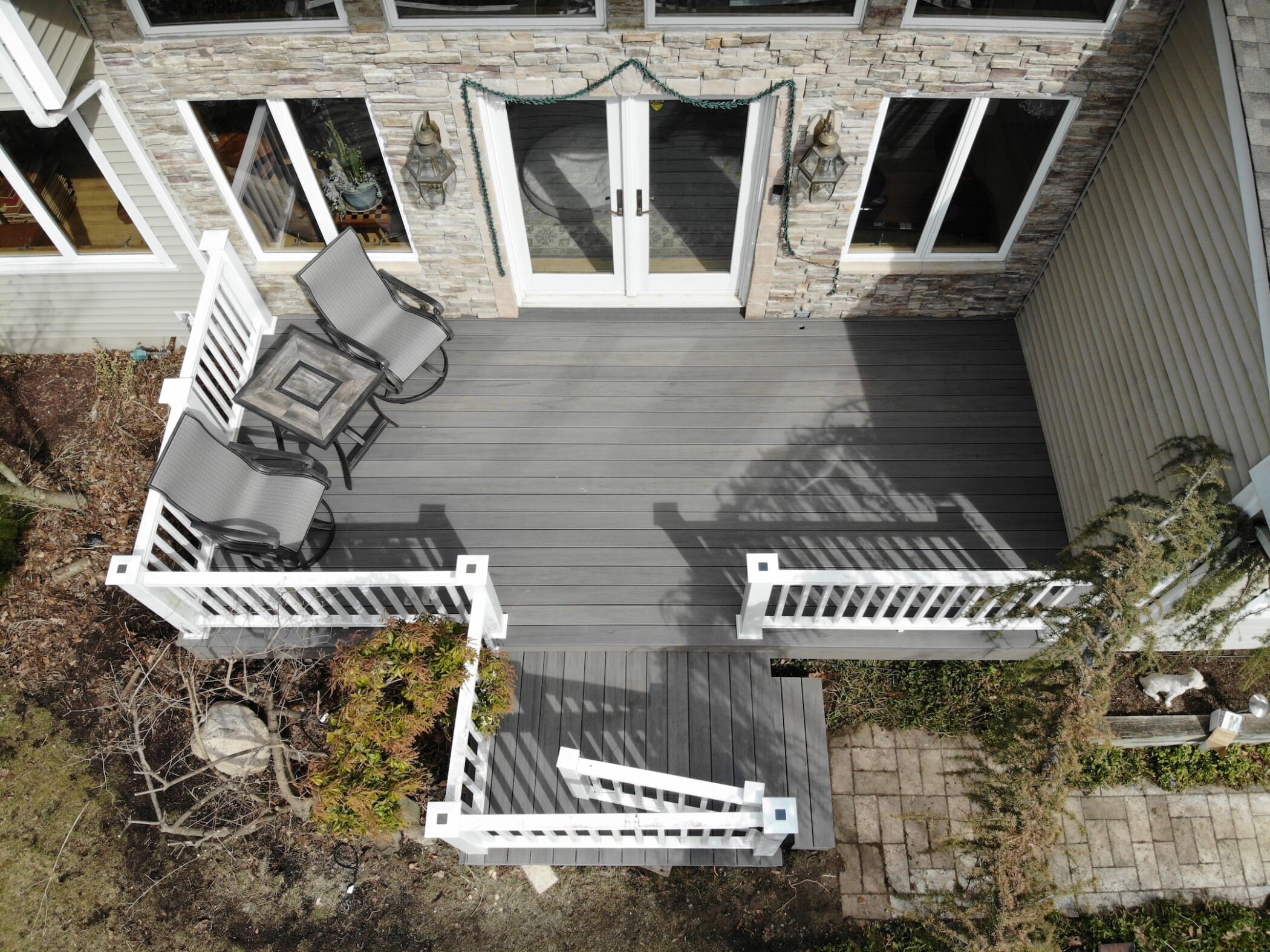 gray deck installation by blue nail exteriors