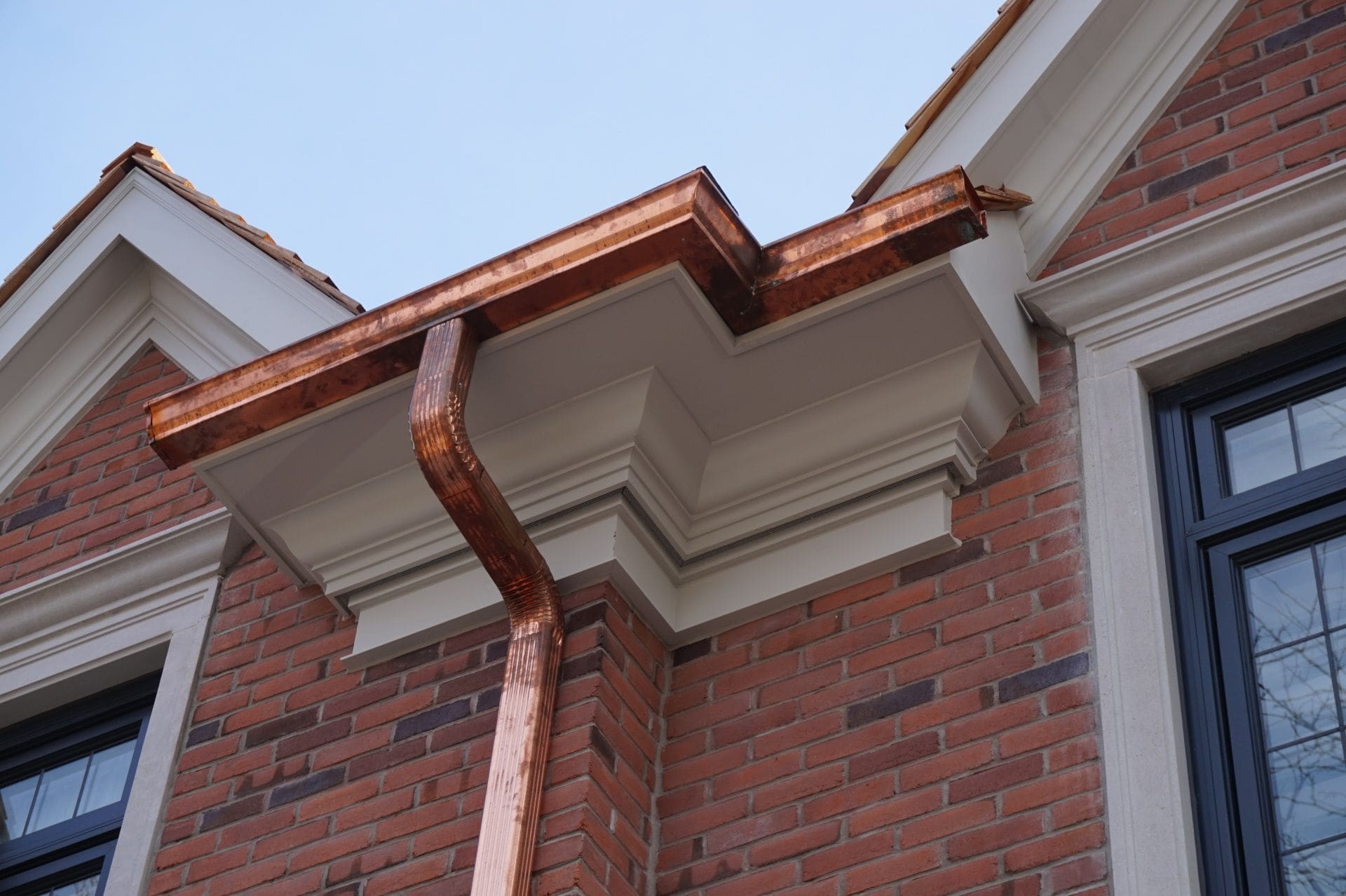 blue nail exteriors copper gutter installation brick home